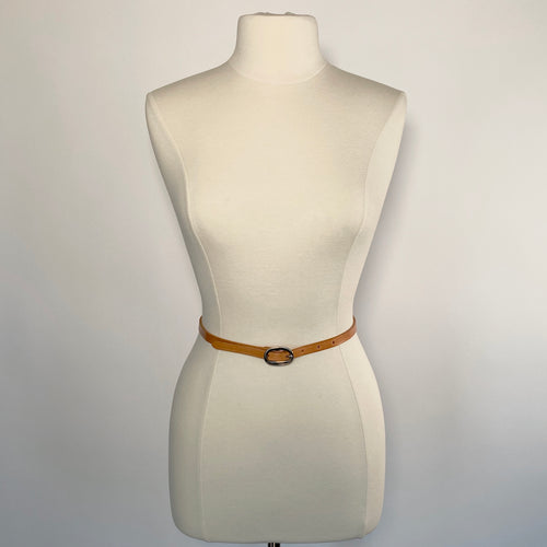 A mannequin with a slim, feminine brown leather belt and a round stainless steel buckle.