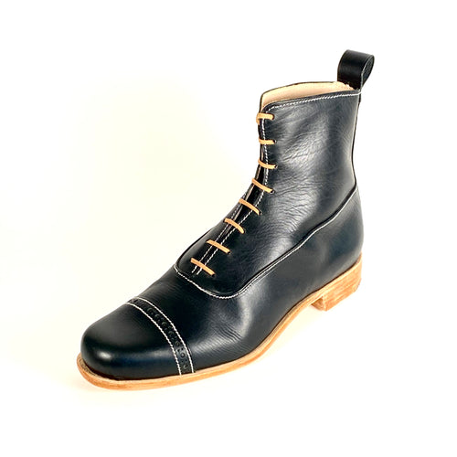 A black leather boot with brown leather sole